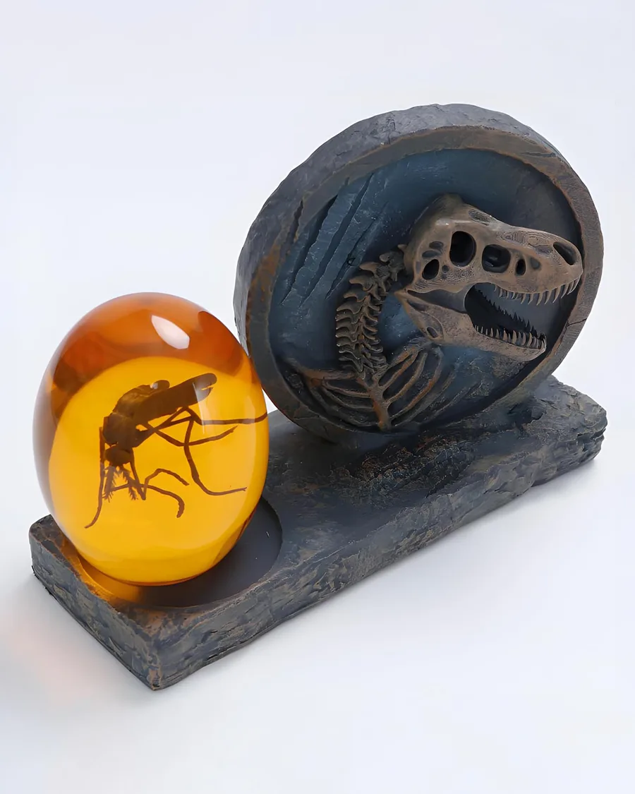 Detailed dinosaur skeleton fossil medallion and amber paperweight with a preserved mosquito, combined size about 4 inches, earthy tones.