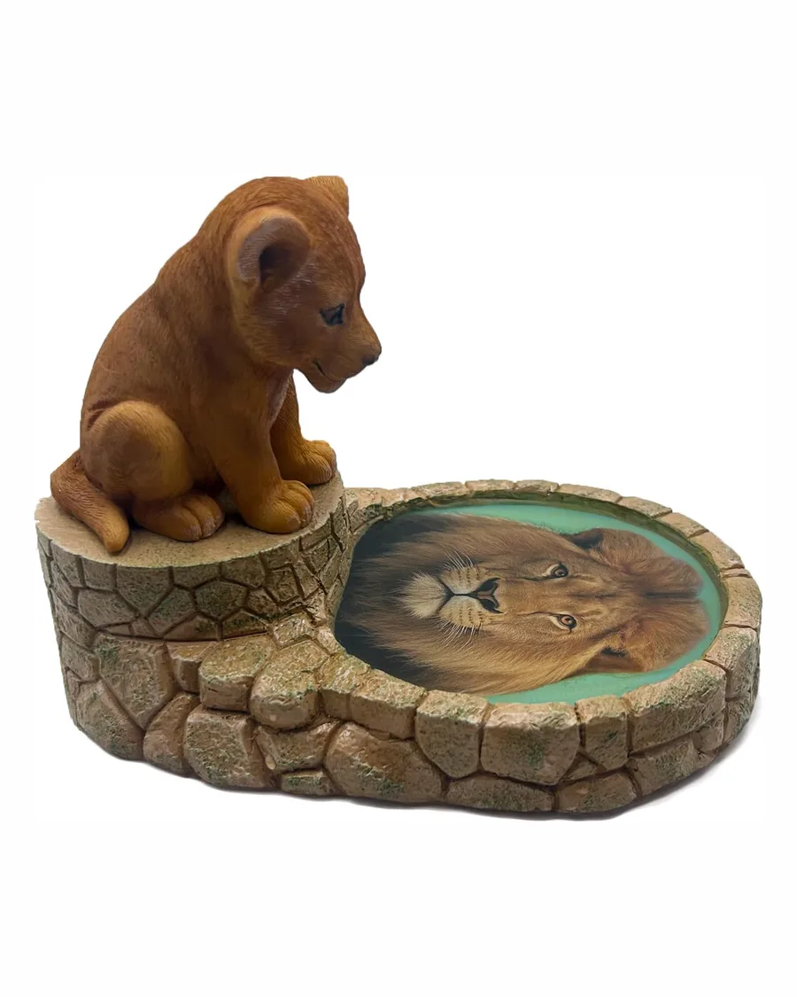 Lion cub figurine made of resin, approx 5 inches tall, features a curious pose looking into reflective water, showcasing a vibrant gold and brown color palette.